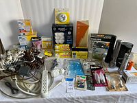 Overall lot showing bulbs, cords, lamp box, flashlights, timers