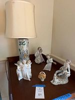 Overview of all five porcelain figurines on table