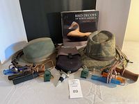 Full lot showing hats, calls, book, socks, stopper, tools