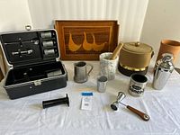 All items in lot laid out, including shaker, ice bucket, mortar, tray, tool set and others