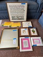 All nine framed items and two plastic buses arranged together for overview