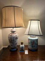 Front view of both table lamps with shades and small porcelain fragrance bottle