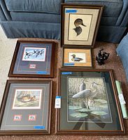 All five framed bird prints, sculpture and rolled poster shown together
