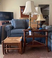 Overview showing corner table, three nesting stools, brass lamp, metal lamp