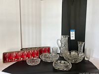Entire lot with pitcher, bowls, vase, tumbler, dishes and two boxed sets of goblets