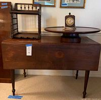 All four items: drop-leaf table (leaves down), two-tier stand, lazy Susan, mantel clock