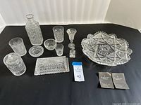 Entire lot arranged on black backdrop displaying all crystal pieces and booklets