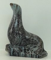 Front view of ceramic seal figurine showing glaze pattern
