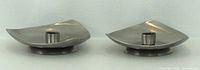 pair of candle holders side view showing triangular curved shape