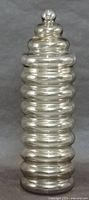 Full view of ribbed smokey glass jar with lid in place