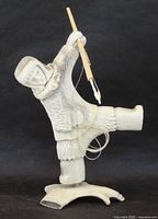 Front view of antler carving showing hunter pose, harpoon, and base