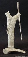 Front view of antler sculpture showing Inuit hunter, harpoon, coiled line, mounted on antler base