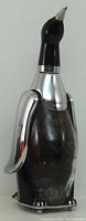 Front view of penguin decanter showing chrome wings and beak