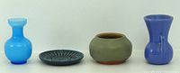 All four miniature items lined up: light blue glass vase, dark blue ceramic dish, matte green bowl, blue pottery vase