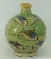 front view of round green vase with painted fish