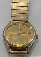 Front view of Gruen Precision wristwatch showing dial, hands, date window and expansion band