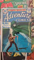 Stack showing Adventure Comics #431 bagged with note and partial view of other Spectre comics
