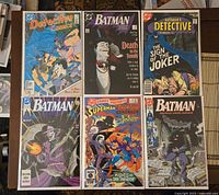 Six comics laid out showing covers Batman #429, Detective Comics #476 & #570, Batman #451 & #450, DC Comics Presents #72