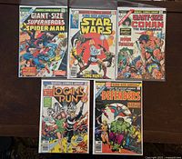 Front covers of all five bagged comics laid out