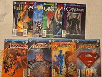Front view of eight comics including four Action Comics Oz Effect and four New 52 Futures End issues