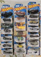 Full lot of three columns showing all 18 carded Hot Wheels