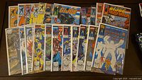 All 22 bagged comics fanned out on table