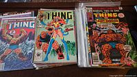 Stacks of The Thing and Marvel Two-In-One comics, many bagged