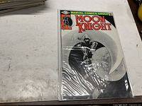 Front view of bagged Moon Knight #15 comic showing cover and condition