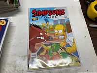 Front cover of Simpsons Comics #193 in bag and board