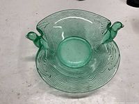 Top view showing entire green uranium glass bowl with twin bird handles
