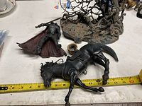 Figure, horse and measuring tape showing size