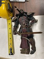 Full figure beside tape measure showing size