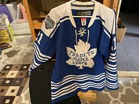 Front view of blue Toronto Maple Leafs Winter Classic jersey with maple leaf logo and #21 sleeves