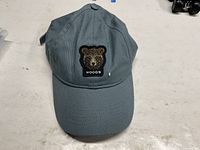 Top view of cap showing bear head Woods patch and overall color