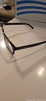 Left temple and hinge detail of Burberry tortoiseshell eyeglass frame