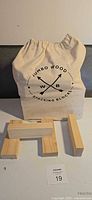 Bag with printed logo and several wood blocks displayed