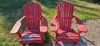 Both red wooden Adirondack chairs front view