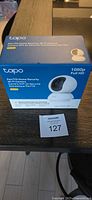 Box of TP-Link Tapo pan/tilt Wi-Fi camera showing product image and specs