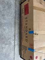 Sealed shipping carton showing Standard Furniture branding