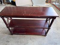 Front view of three-tier console table showing overall structure