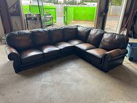 Full view of dark brown leather L-shaped sectional sofa