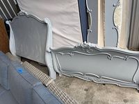Headboard and footboard front view showing design, color and wear