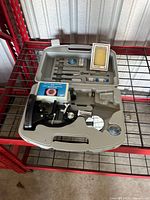 Open case showing microscope and accessories