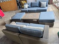 Overall view of modular resin wicker sectional set with cushions and table