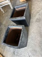 Two charcoal square tapered planters exterior view
