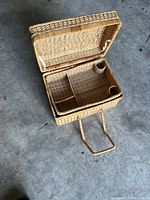 Basket open showing interior tray compartments and lid hinge