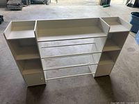 Front angled view showing entire counter, hanging rods, side towers