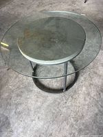 Overall view of table with glass top resting on frame