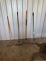 Front view of four bow rakes standing upright