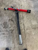 Overall view of Tasco red optical tube attached to folded tripod